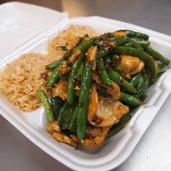 Three Happiness Express's chicken and green beans with fried rice in a takeout container.