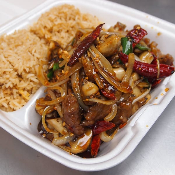 Three Happiness Express's spicy beef with onions, mushrooms, and red chilies, served with fried rice.